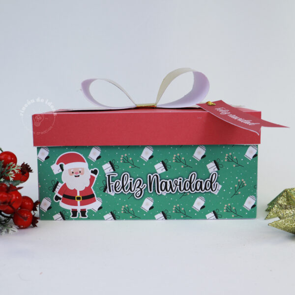 Caja verde con tapa roja, Papá Noel, moño blanco y cinta Feliz Navidad · Navidad en Rincón