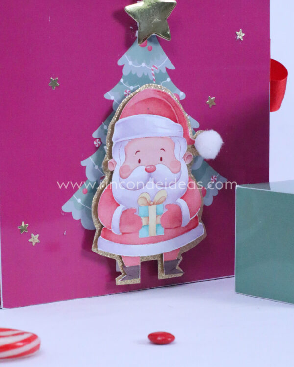 Detalle de Papá Noel con arbolito y pompón en la tapa · Masterclass de calendarios de adviento, esferas y topper